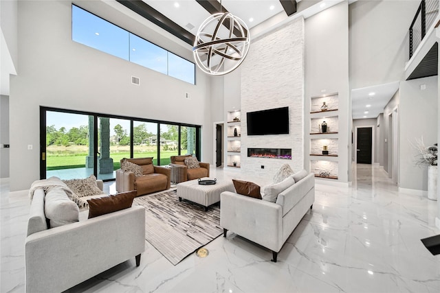 living room with a fireplace, built in features, and a chandelier