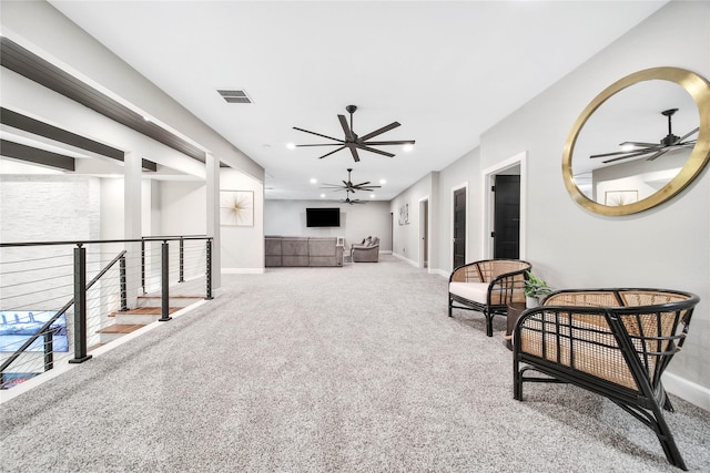 living area featuring ceiling fan and carpet flooring