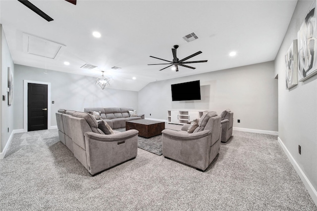 living room featuring vaulted ceiling, light colored carpet, and ceiling fan