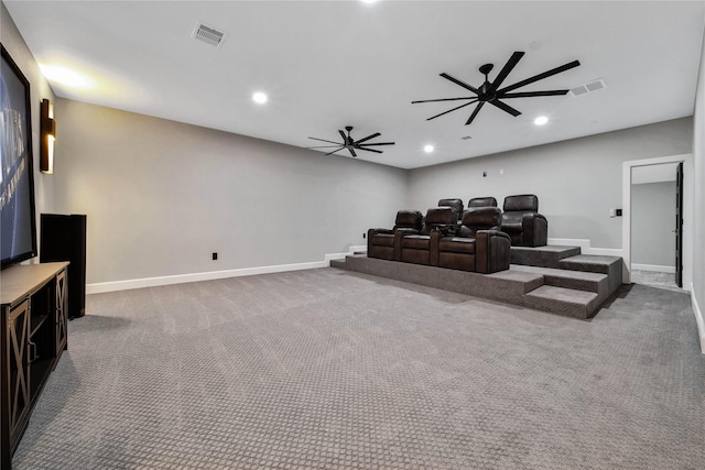 cinema room with ceiling fan and carpet flooring