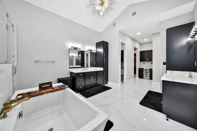 bathroom with an inviting chandelier, vanity, separate shower and tub, and high vaulted ceiling