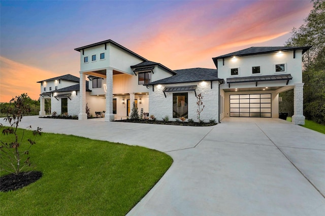 contemporary house with a garage and a lawn