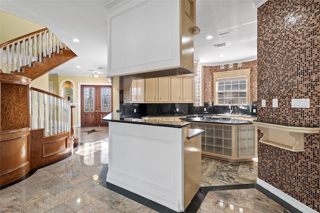 kitchen with dark countertops, a peninsula, marble finish floor, french doors, and recessed lighting