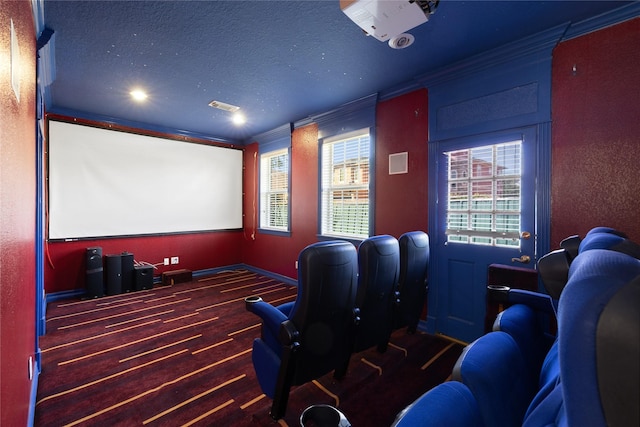 cinema featuring a textured ceiling, visible vents, and crown molding