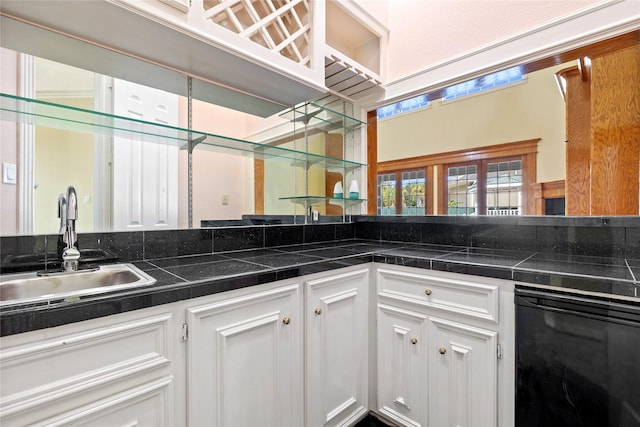 kitchen featuring a sink and white cabinetry