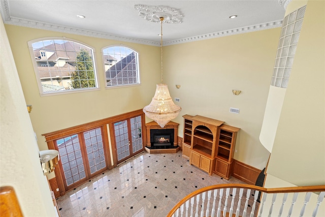 foyer entrance with tile patterned floors, recessed lighting, visible vents, and a glass covered fireplace