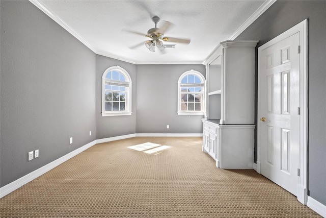 unfurnished room with light carpet, ceiling fan, ornamental molding, and baseboards