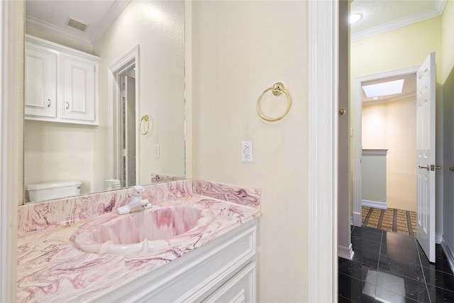 half bath featuring toilet, visible vents, vanity, baseboards, and ornamental molding