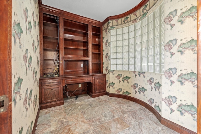 office area with wallpapered walls, baseboards, ornamental molding, and built in study area