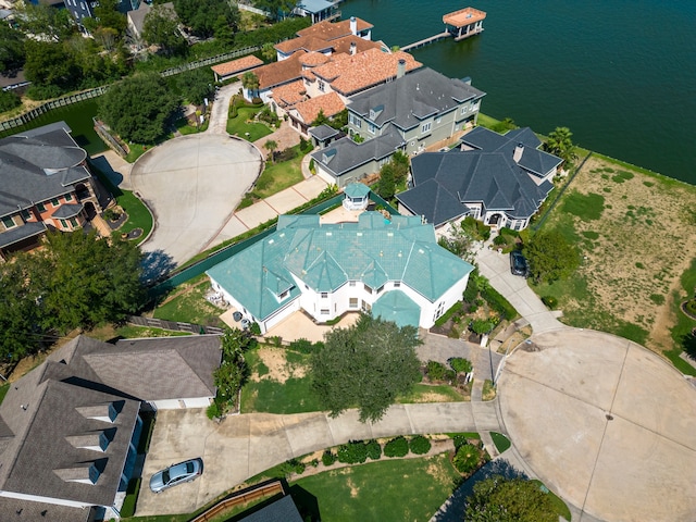 drone / aerial view with a water view and a residential view