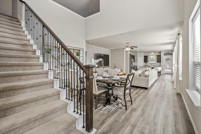 interior space with ceiling fan, hardwood / wood-style flooring, and crown molding