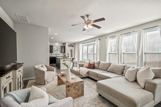 living room featuring ceiling fan and light wood-type flooring