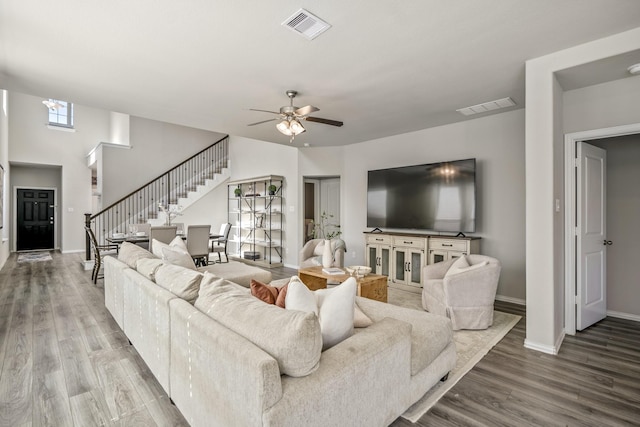 living room featuring ceiling fan and hardwood / wood-style flooring