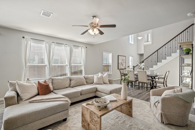 living room featuring ceiling fan and light hardwood / wood-style flooring