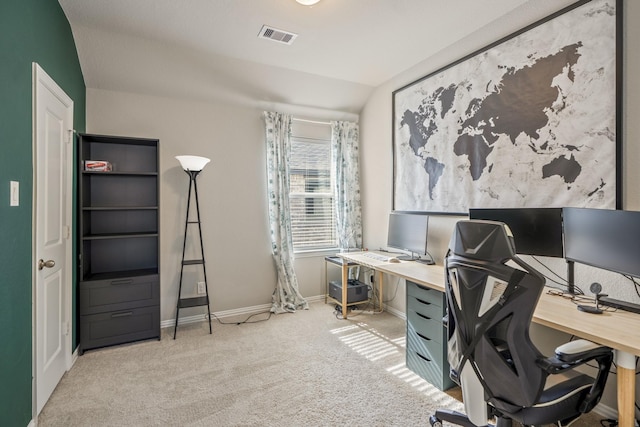 office area with light colored carpet and vaulted ceiling