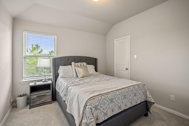 carpeted bedroom featuring multiple windows and vaulted ceiling