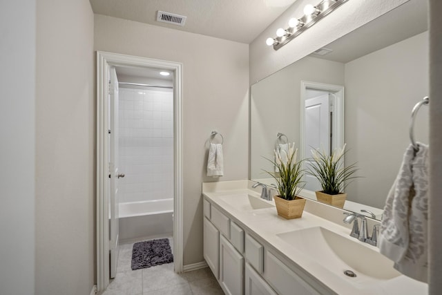 bathroom featuring tiled shower / bath combo, a textured ceiling, tile patterned floors, and vanity