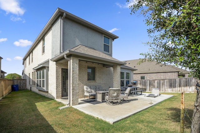 rear view of property with a patio area and a lawn