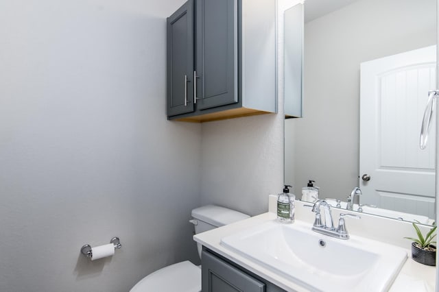 bathroom with toilet and vanity