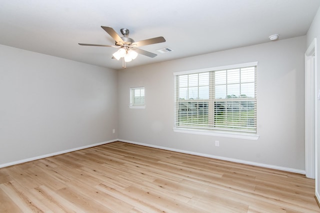 unfurnished room featuring baseboards, ceiling fan, visible vents, and light wood-style floors