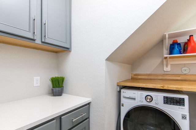 laundry area with washer / dryer and cabinets