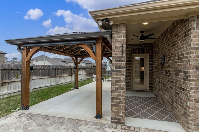 view of patio / terrace with ceiling fan and fence