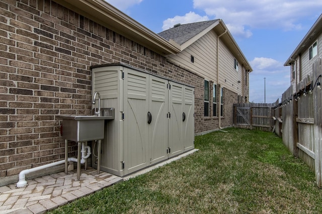 exterior space with an outbuilding, a fenced backyard, and a shed