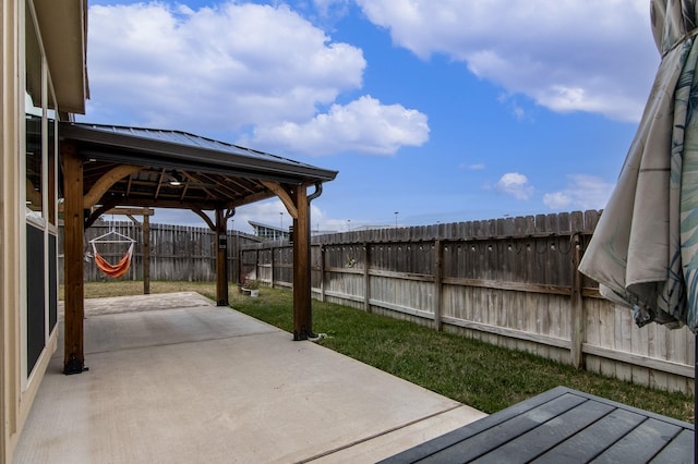 view of patio featuring a gazebo and a fenced backyard