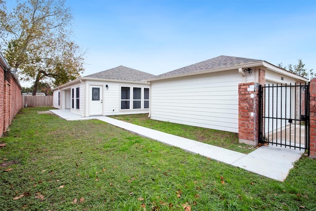 back of house with a yard