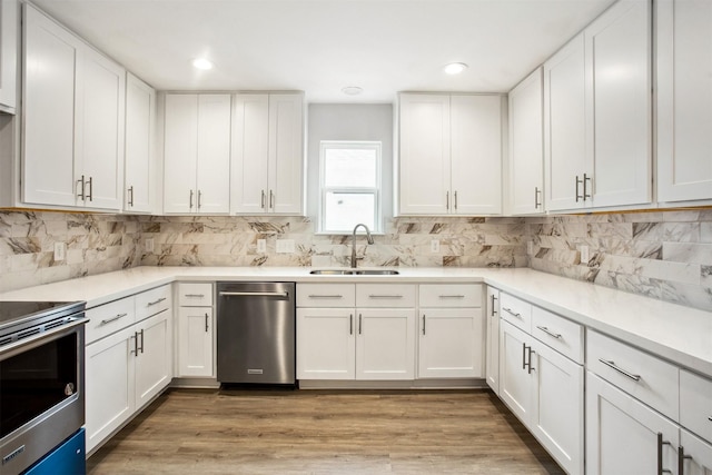 kitchen featuring white cabinets, appliances with stainless steel finishes, and sink