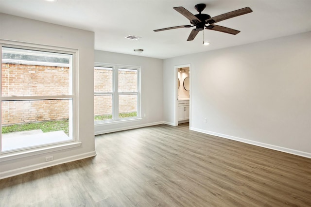 spare room featuring ceiling fan and dark hardwood / wood-style flooring