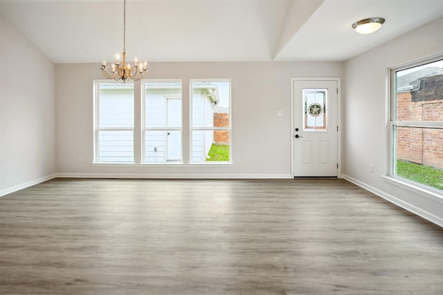 entrance foyer with hardwood / wood-style flooring and a notable chandelier