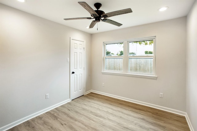 spare room with ceiling fan and light hardwood / wood-style floors