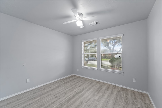 empty room with ceiling fan and light hardwood / wood-style floors