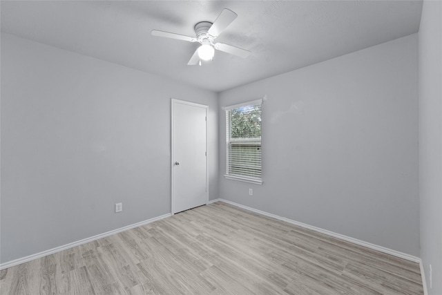 empty room with ceiling fan and light hardwood / wood-style flooring