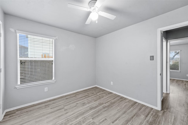 empty room with ceiling fan and light wood-type flooring