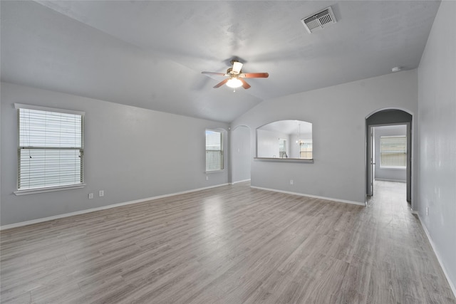 empty room featuring ceiling fan, plenty of natural light, and light hardwood / wood-style flooring