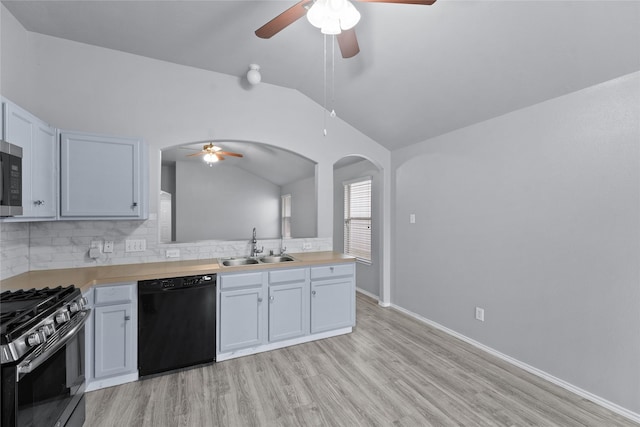 kitchen with vaulted ceiling, gas stove, wooden counters, black dishwasher, and sink