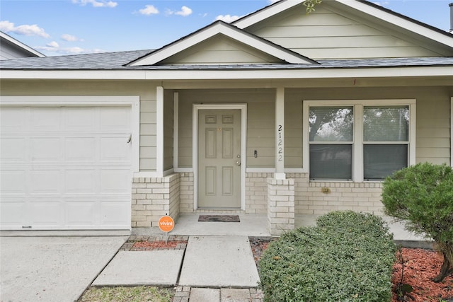 entrance to property with a porch and a garage