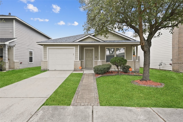 view of front of home featuring a porch, a front lawn, and a garage