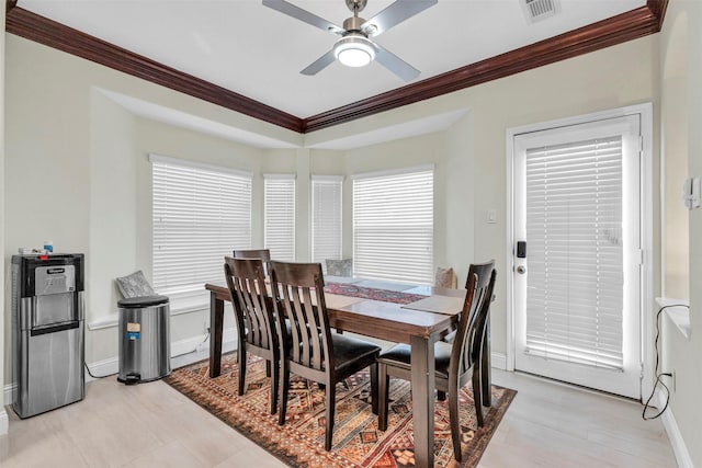 dining space featuring ceiling fan and crown molding