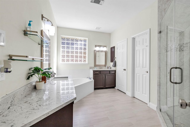 bathroom with vanity and plus walk in shower