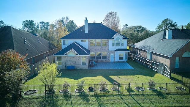 rear view of property with a patio area and a yard