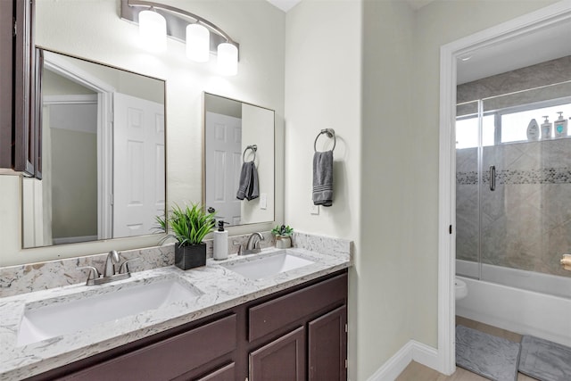 full bathroom featuring enclosed tub / shower combo, vanity, and toilet