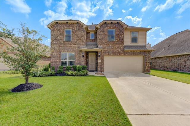 view of front of property with a front lawn and a garage