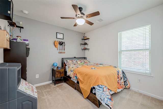 bedroom with ceiling fan and light colored carpet