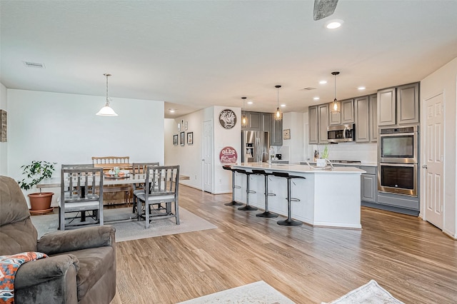 living room featuring light wood-type flooring and sink