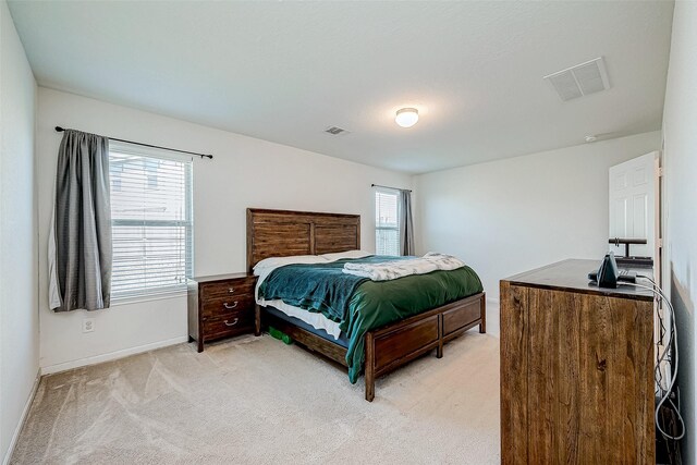 carpeted bedroom featuring multiple windows