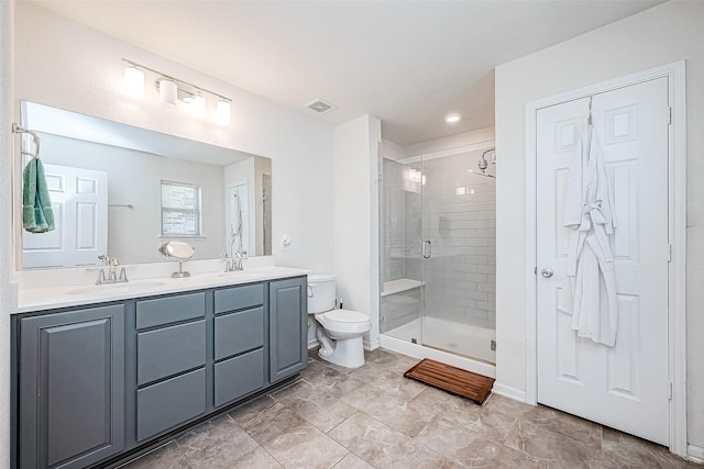 bathroom featuring toilet, a shower with door, and vanity