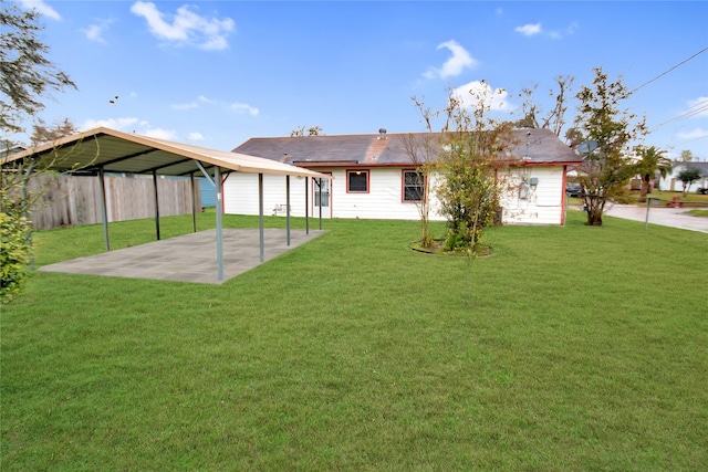 back of property with fence and a lawn